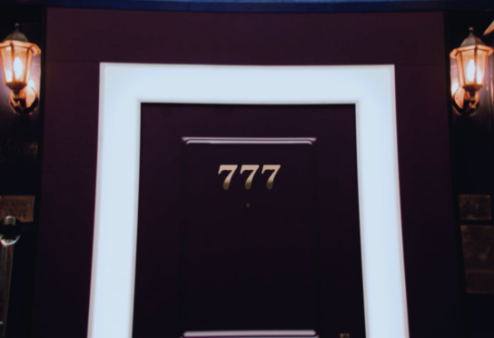 Image of door with three gold sevens as address on door